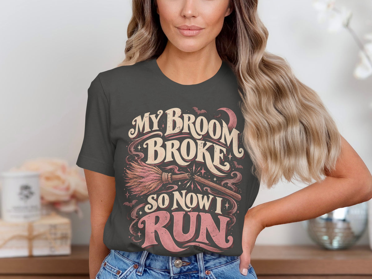 Dark grey t-shirt with "My Broom Broke So Now I Run" text and Halloween graphic.