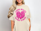 Cream t-shirt with pink graphic text reading "LONG MILES RUN HIGH VIBES."
