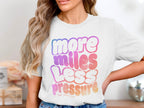 White t-shirt with "more miles less pressure her pace run" graphic