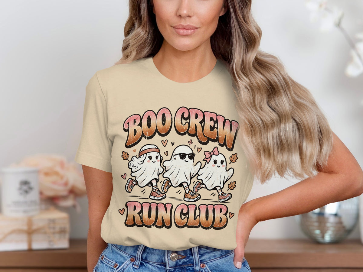 Three cartoon ghosts running with text "BOO CREW RUN CLUB" on a tan shirt.