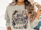 Crewneck sweatshirt with "Bad Witches Run Club" graphic and Halloween-themed illustrations.