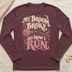 Maroon long-sleeve t-shirt with a graphic of a broken broom and text reading My Broom Broke So Now I Run.