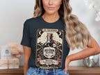 T-shirt graphic featuring "Delusion Elixir" bottle, mountains, stars, and marathon warning.