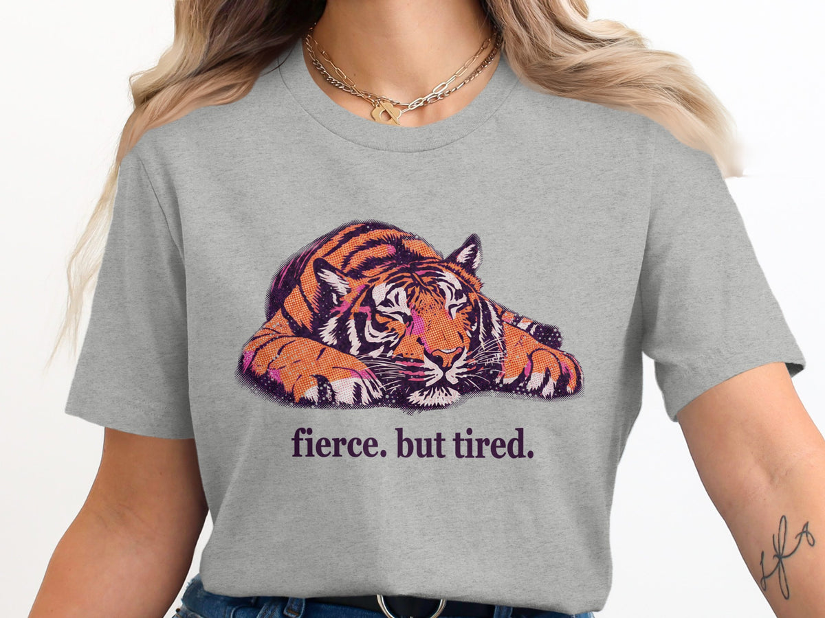 Grey t-shirt with a stylized tiger graphic and the text "fierce. but tired."