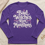 Purple long-sleeve shirt with "Bad Witches Run Marathons" text and celestial graphics.