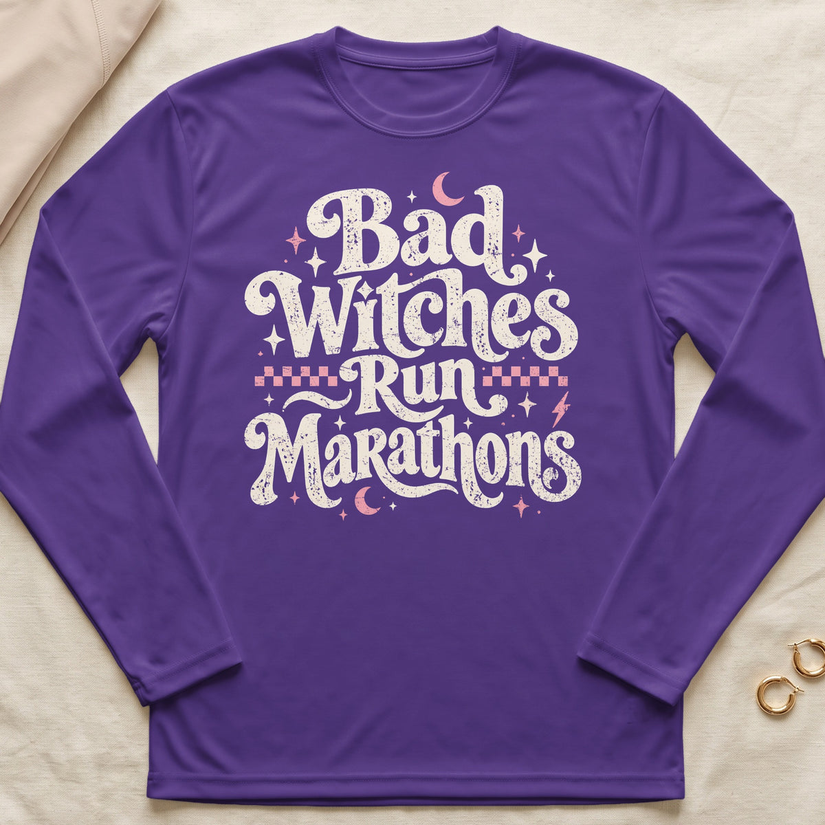 Purple long-sleeve shirt with "Bad Witches Run Marathons" text and celestial graphics.