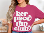 Pink t-shirt with white text "her pace run club".