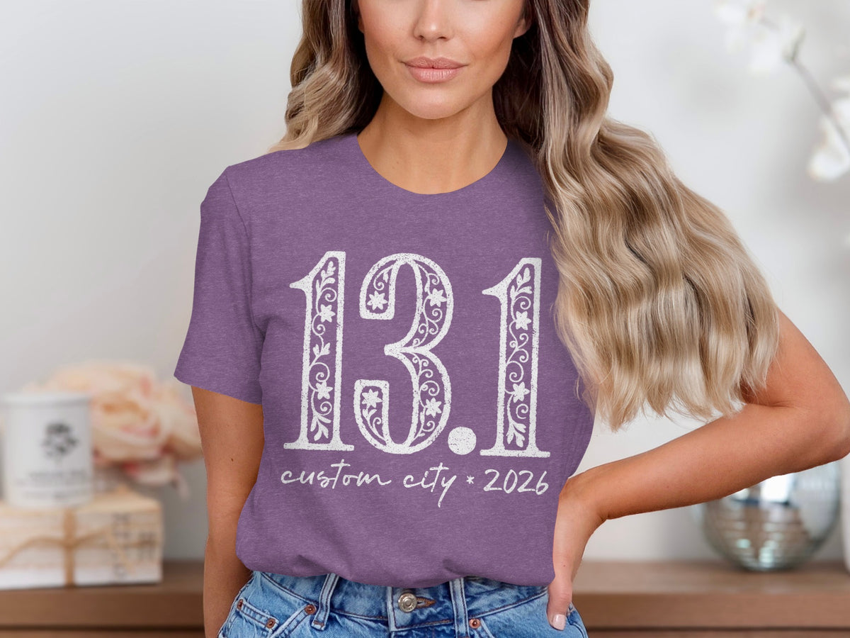 Purple t-shirt with "13.1 custom city * 2026" in white distressed lettering.