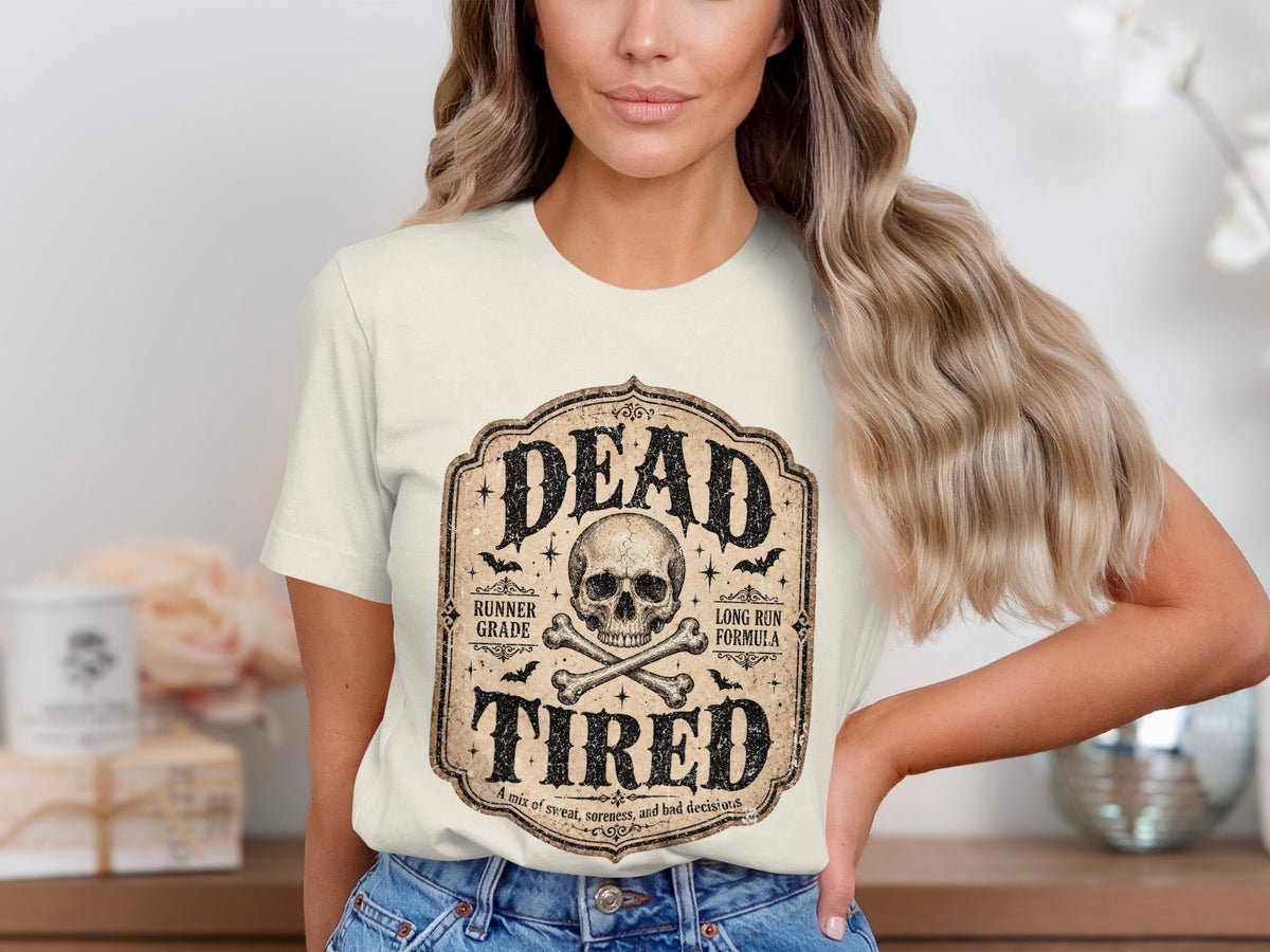 Cream t-shirt with "DEAD TIRED" skull and crossbones graphic.