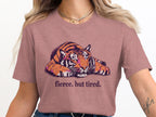 Pink t-shirt with a distressed tiger graphic and the text "fierce. but tired."
