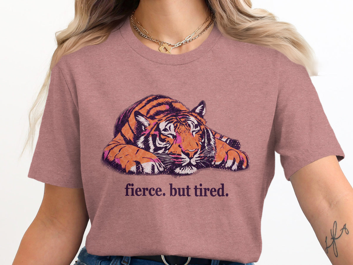 Pink t-shirt with a distressed tiger graphic and the text "fierce. but tired."