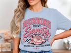 Light blue t-shirt with pink distressed text and graphic of running shoes.