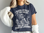 Dark navy t-shirt with white graphic: "I asked myself if I'm okay and we both started laughing"