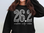 Black sweatshirt with white text "26.2 custom city * 2026"