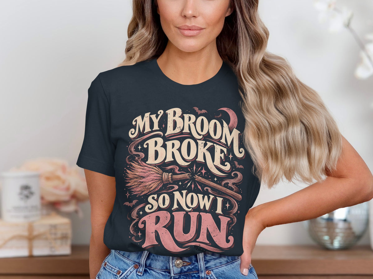 Dark t-shirt with "My Broom Broke So Now I Run" Halloween graphic.
