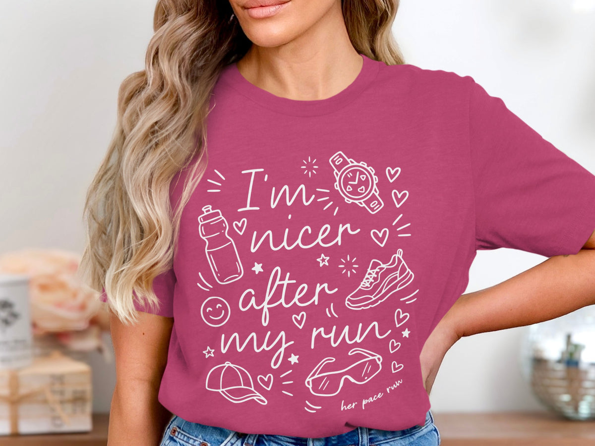 Pink t-shirt with white line art of running gear and text: "I'm nicer after my run."