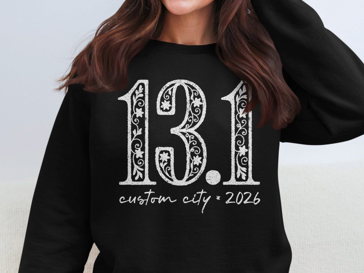 Black sweatshirt with "13.1 custom city * 2026" design.