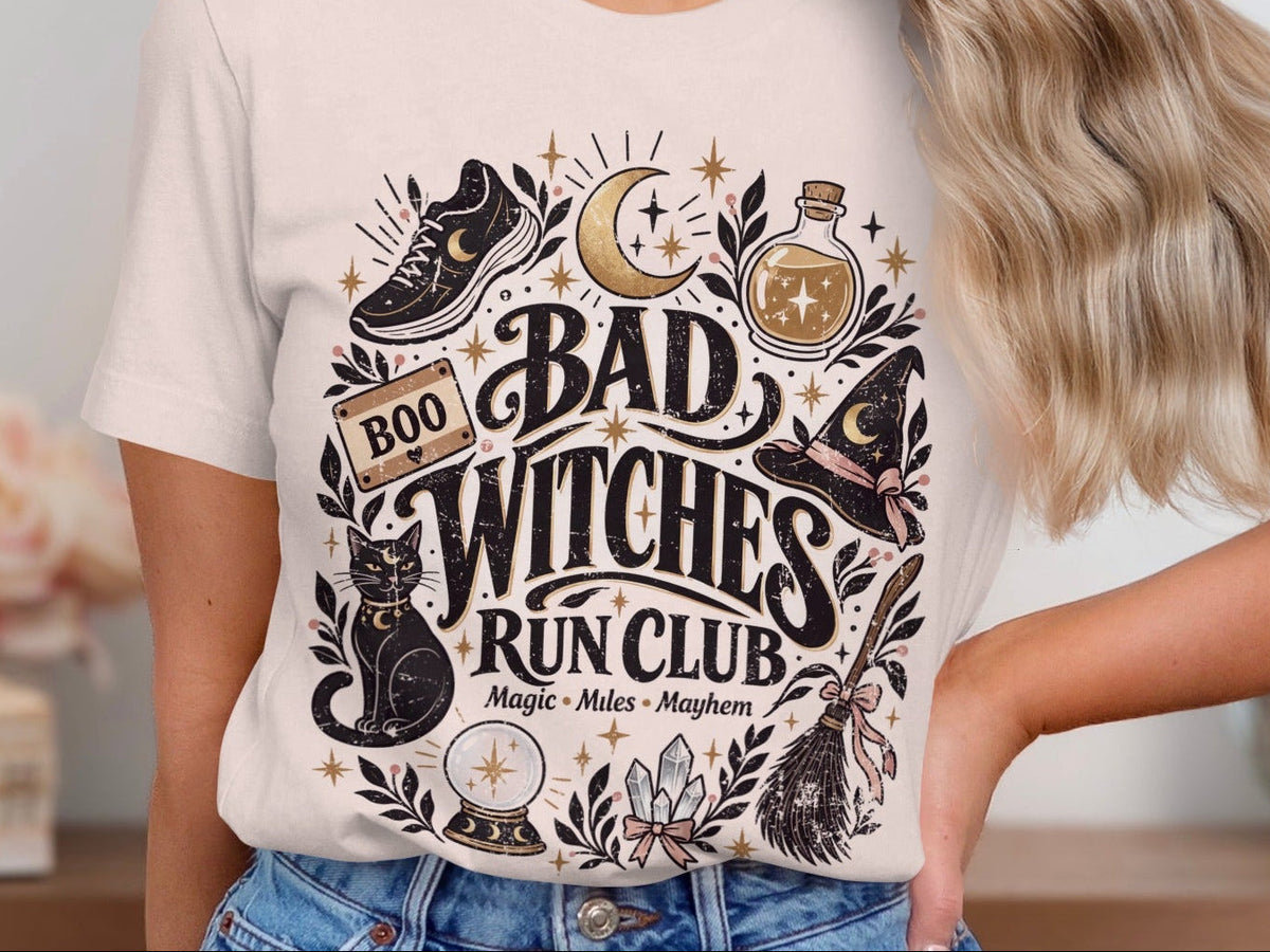 Bad Witches Run Club t-shirt with witchy graphics and text.