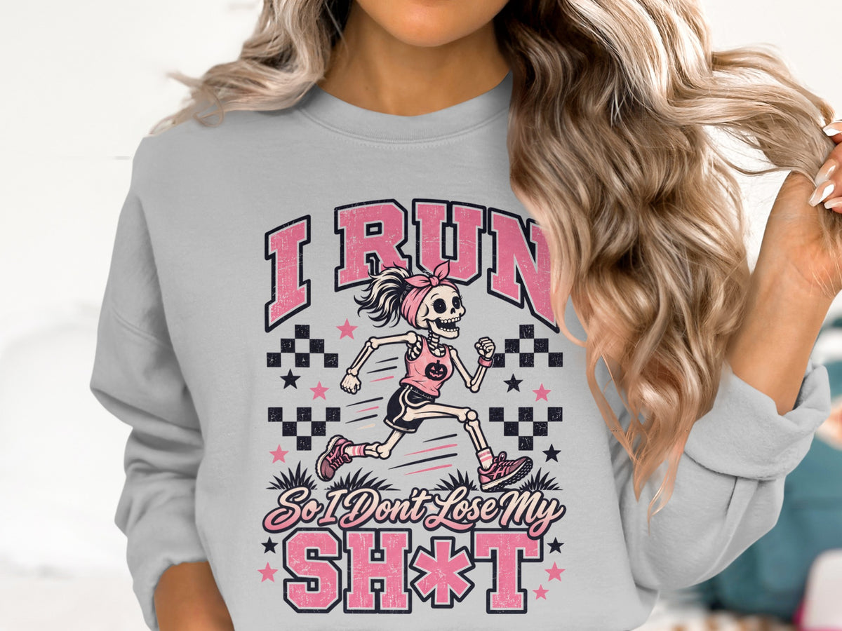 Grey sweatshirt with pink graphic of a skeleton runner and text "I RUN So I Don't Lose My SH*T".