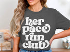 Dark gray t-shirt with white text reading "her pace run club".