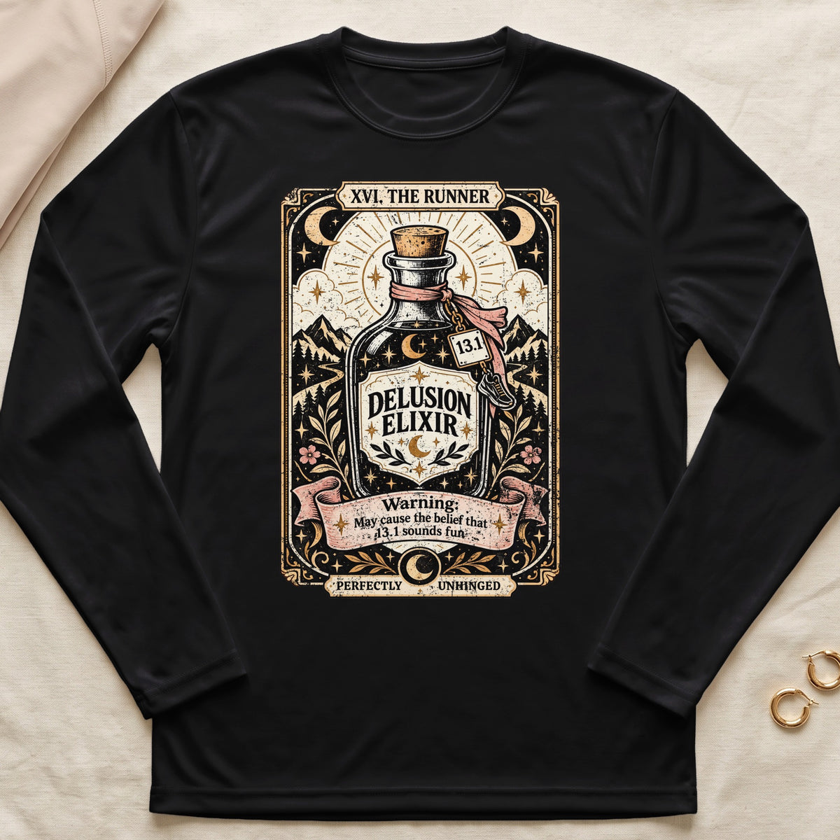 Black long sleeve shirt with "Delusion Elixir" tarot-style design and running motifs.