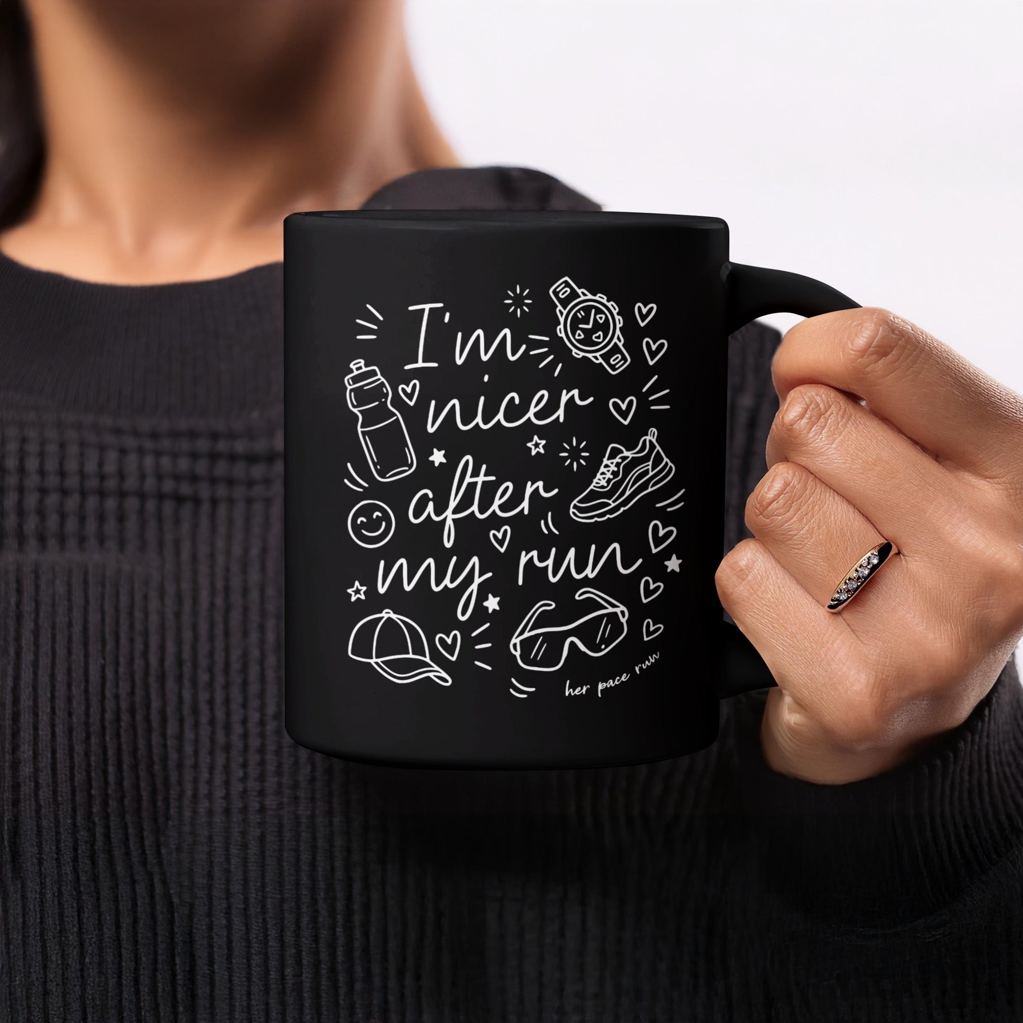 Black mug with white line art of running icons and text "I'm nicer after my run".