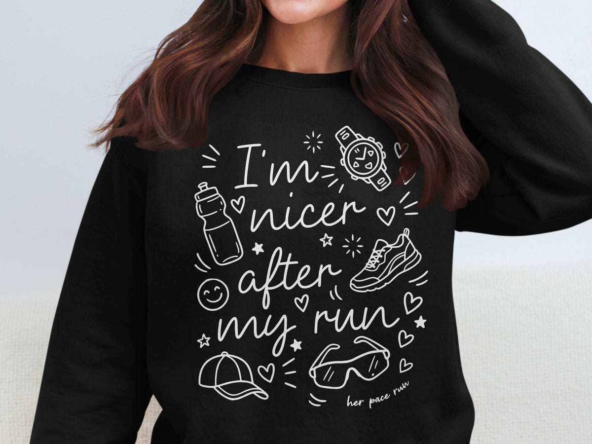 Black sweatshirt with white text and running-themed graphics: "I'm nicer after my run."