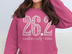 Pink sweatshirt with white text "26.2 custom city 2026"