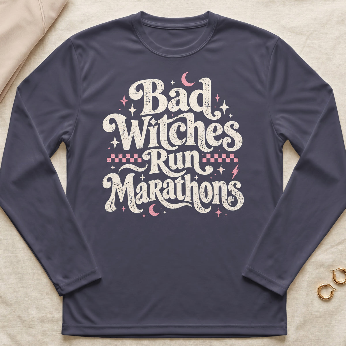 Dark long-sleeve shirt with "Bad Witches Run Marathons" text design.