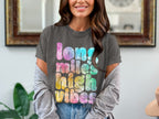 Charcoal t-shirt features "long miles high vibes" in tie-dye text.