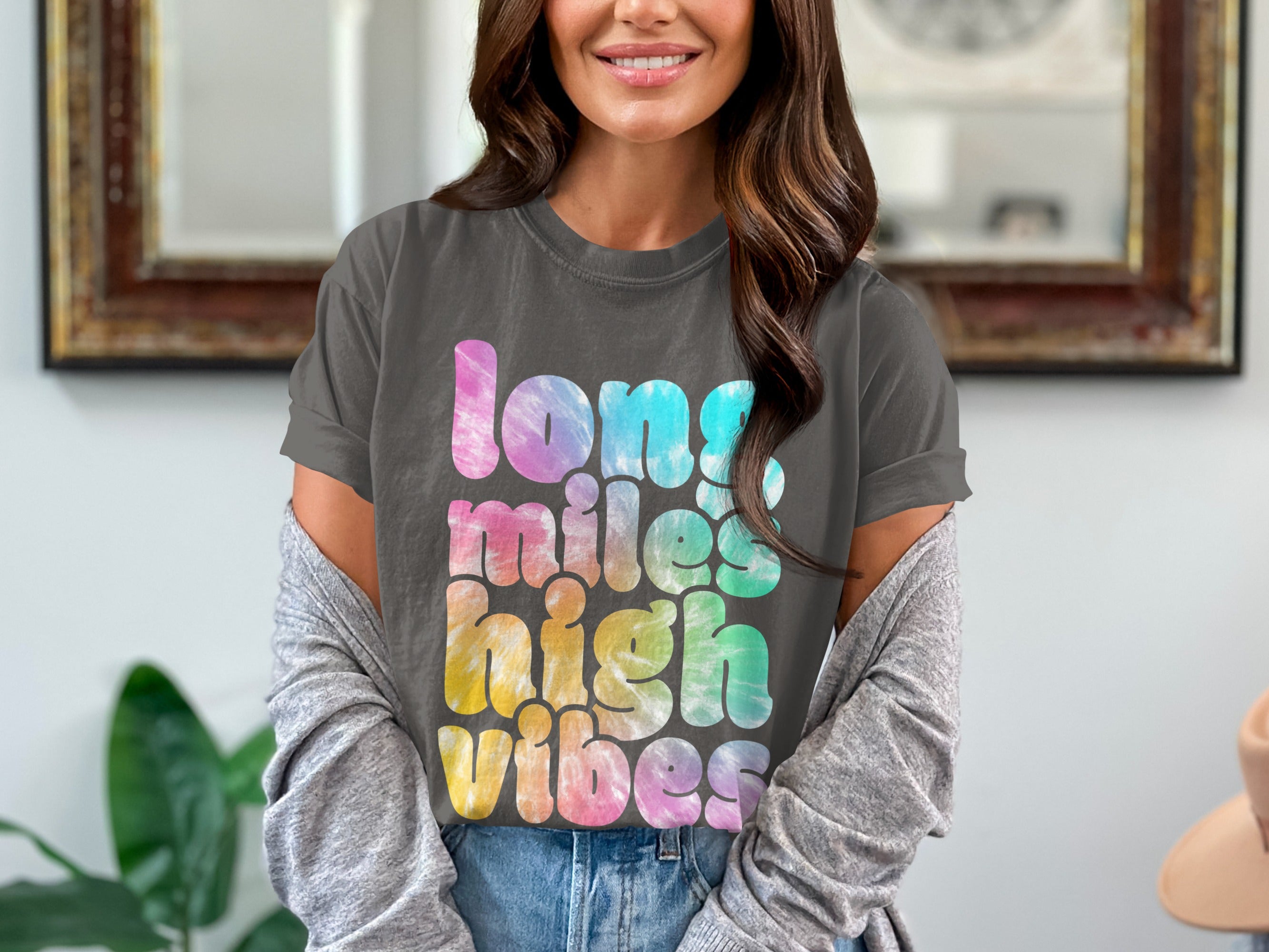 Charcoal t-shirt features "long miles high vibes" in tie-dye text.