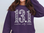 Purple sweatshirt with "13.1 custom city * 2026" in white distressed font.