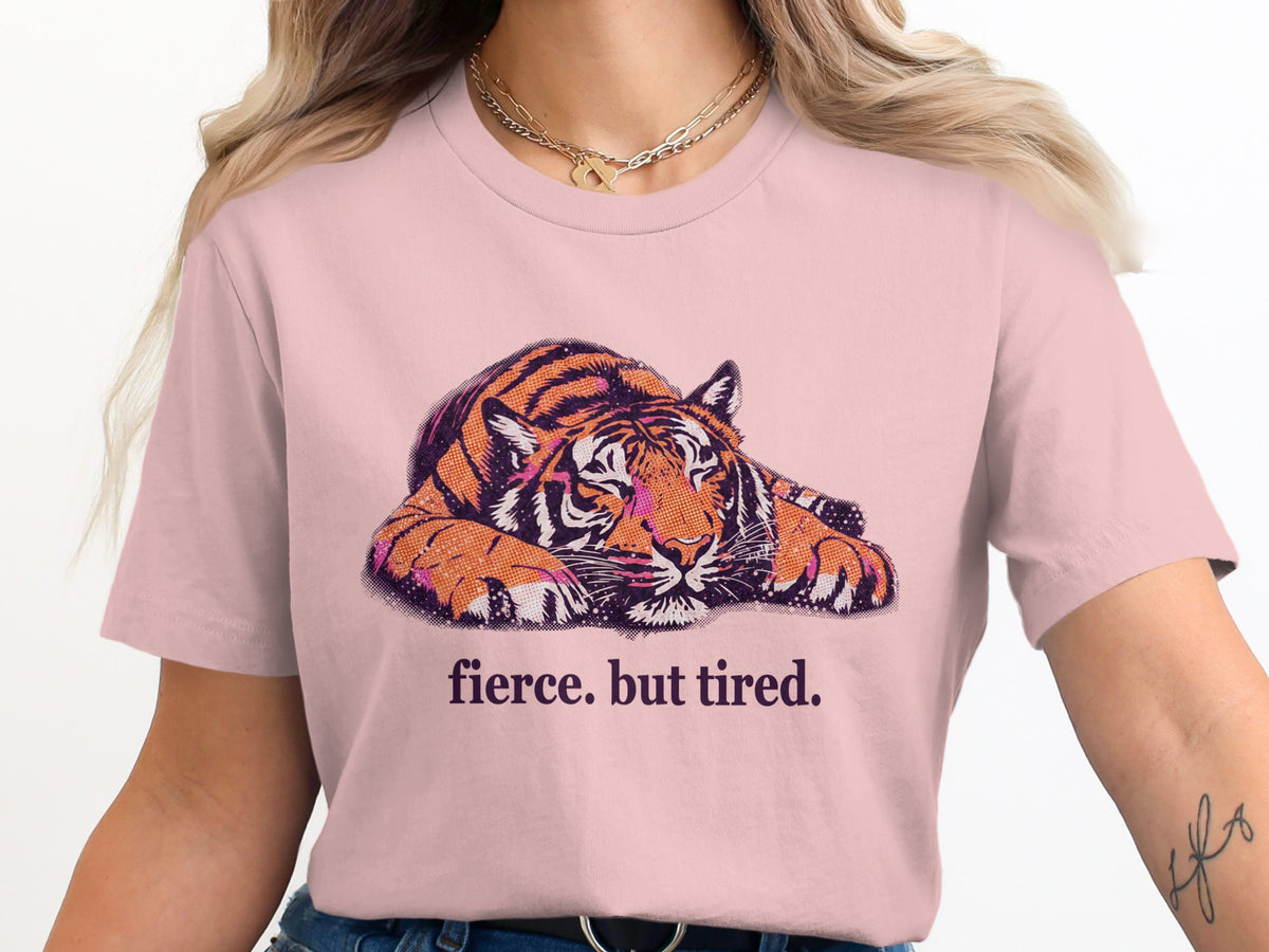 Pink t-shirt with a graphic of a tiger and text that reads "fierce. but tired."