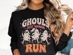Black sweatshirt with graphic of three ghosts running, text "Ghouls Just Wanna Run".