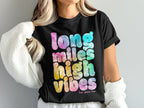 Black t-shirt with tie-dye text reading "Long Miles High Vibes".