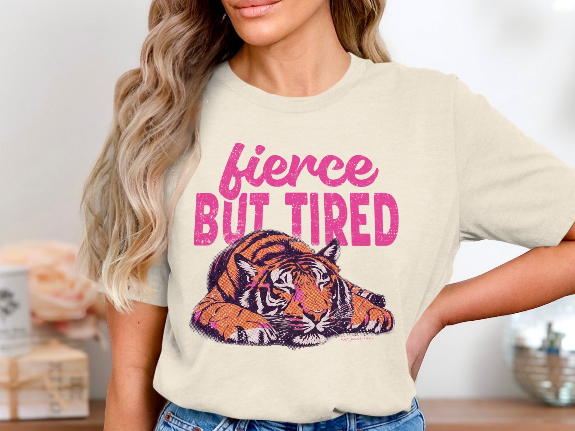 Cream t-shirt with distressed graphic of a tiger and text "fierce BUT TIRED".