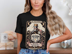 Black t-shirt with "Delusion Elixir" and "XVI. The Runner" text, featuring a bottle and running shoe.