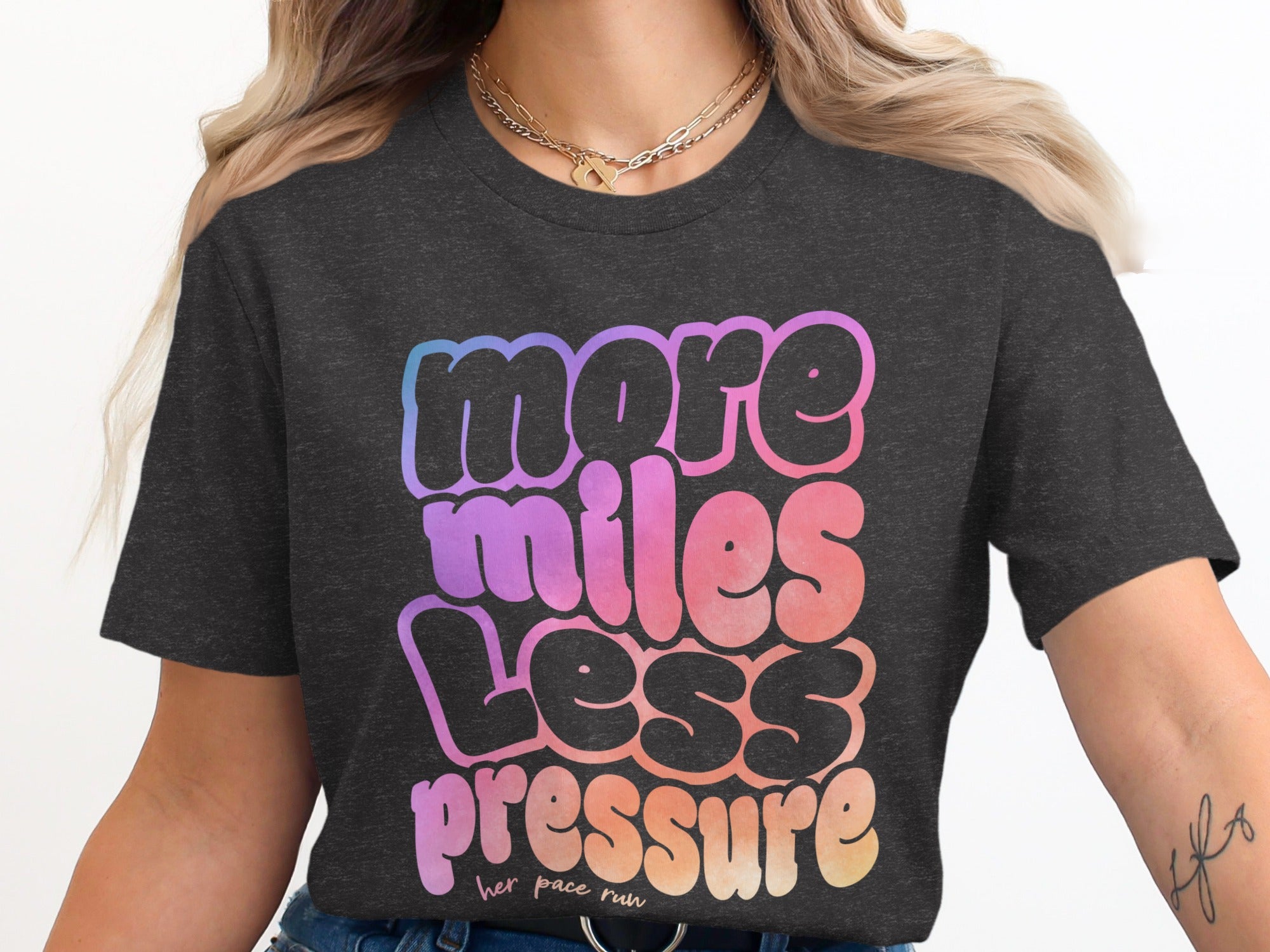Dark grey t-shirt with "more miles less pressure" in gradient bubble letters.