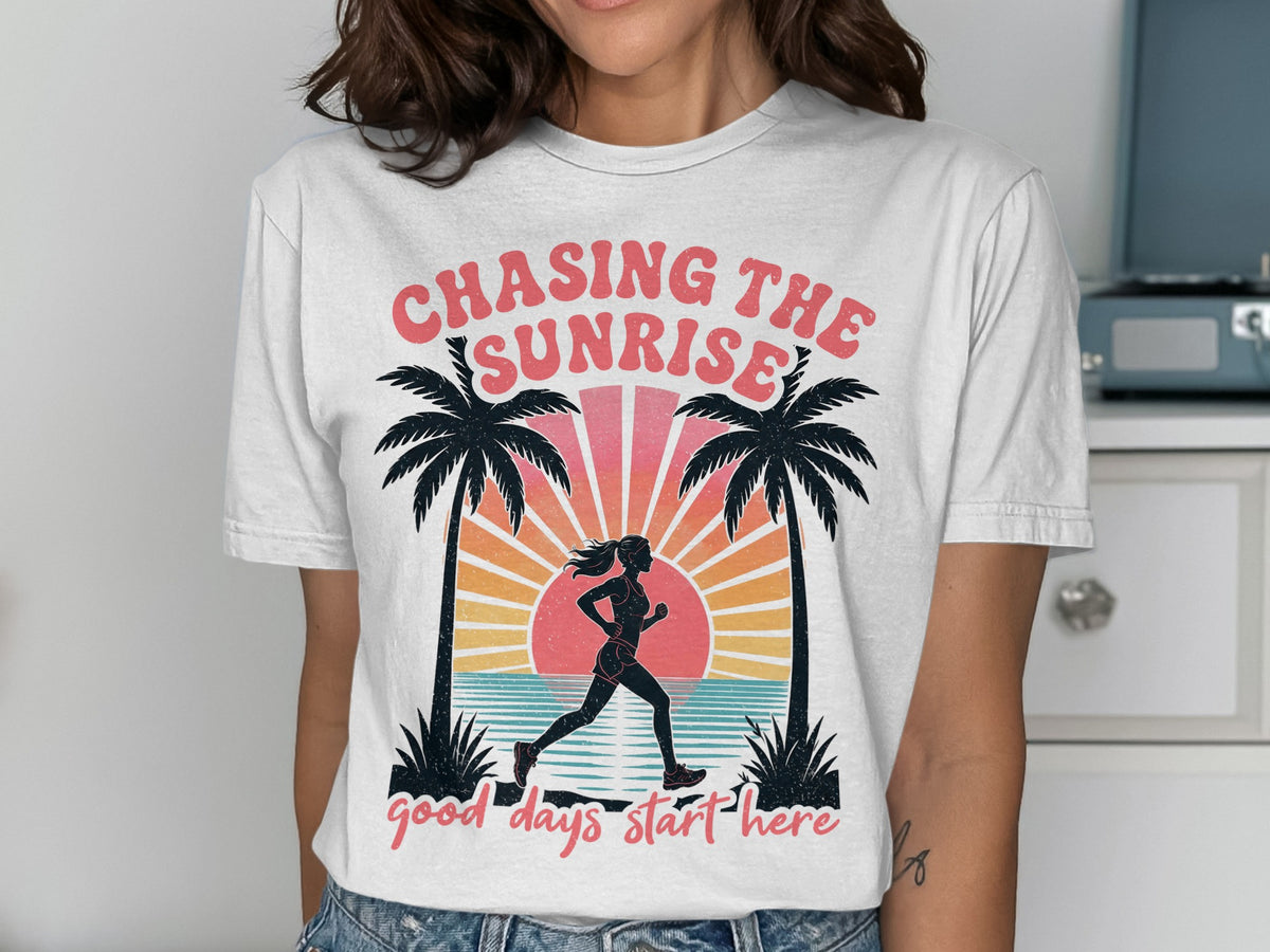 White t-shirt with "Chasing The Sunrise" text and a runner silhouette with palm trees.