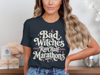 Dark t-shirt with "Bad Witches Run Half Marathons" text in distressed cream and pink.