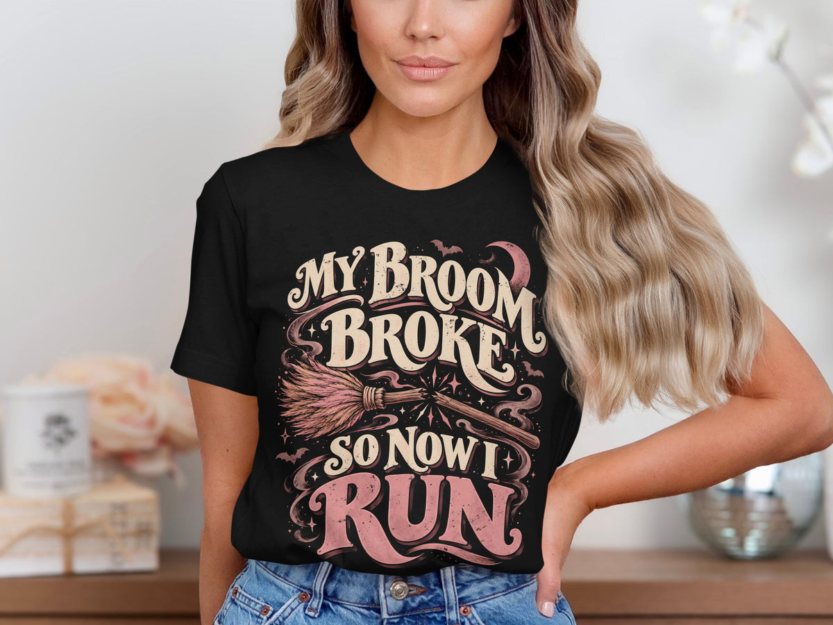 Black t-shirt with "My Broom Broke So Now I Run" text and witch broom design.