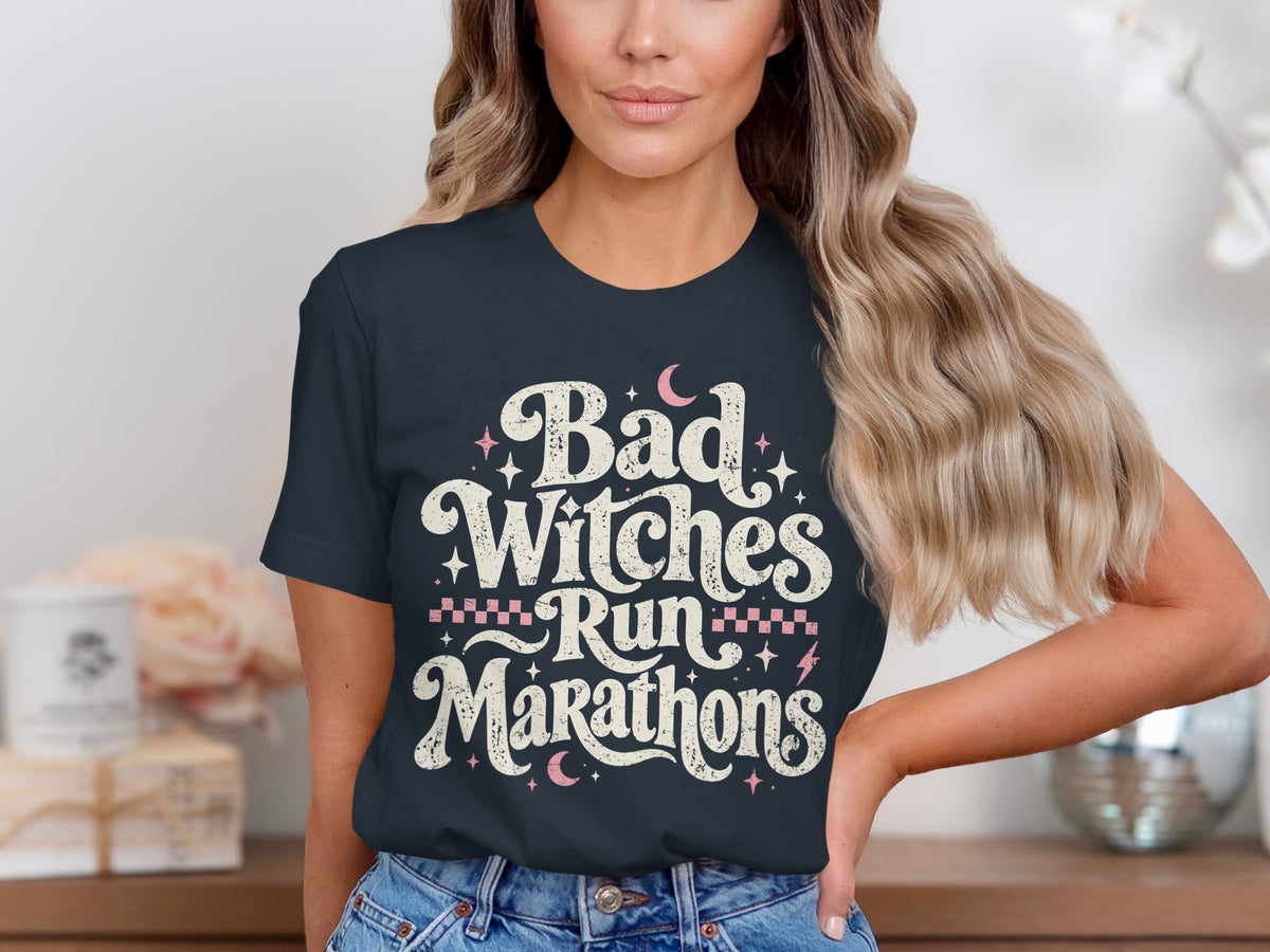 Dark t-shirt with distressed text "Bad Witches Run Marathons" and celestial graphics.